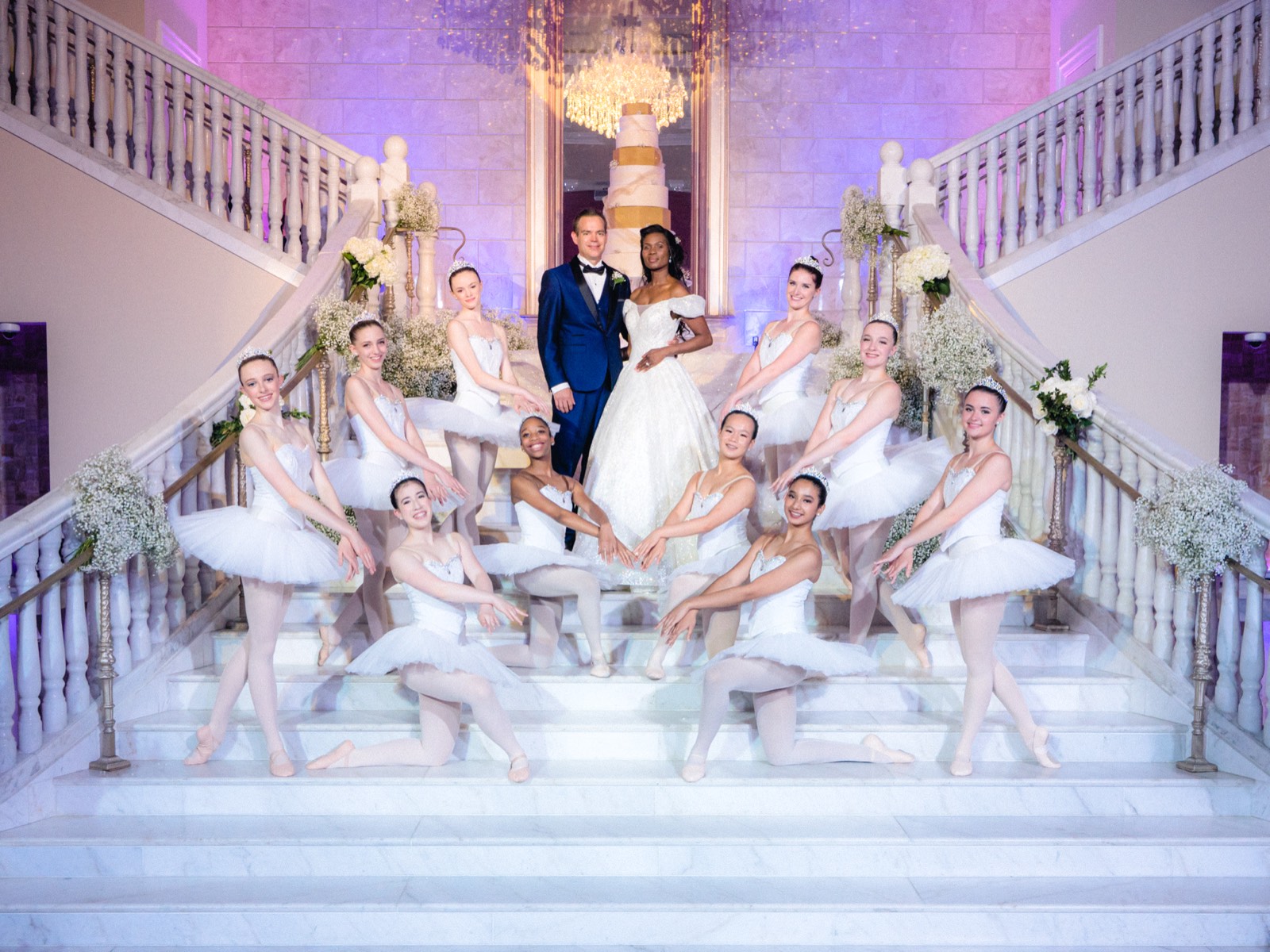Wedding party on a lit staircase at the reception