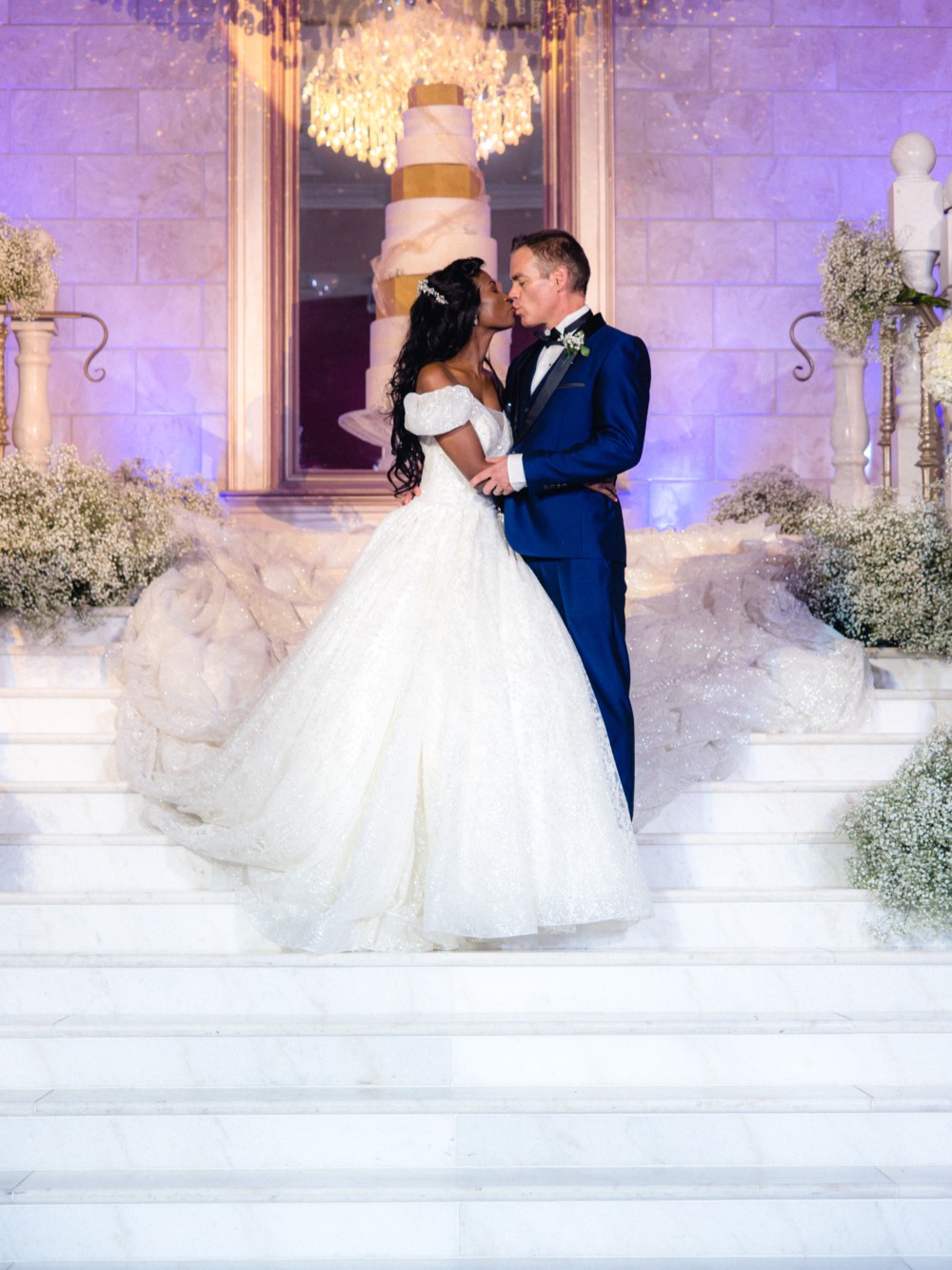 Bride in her gown with the groom behind her