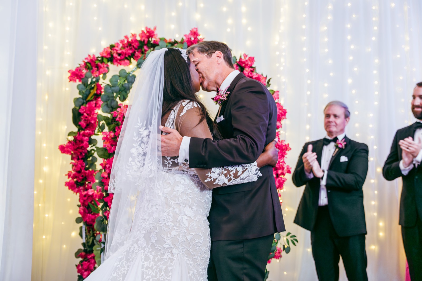 Couple exchanging vows surrounded by flowers