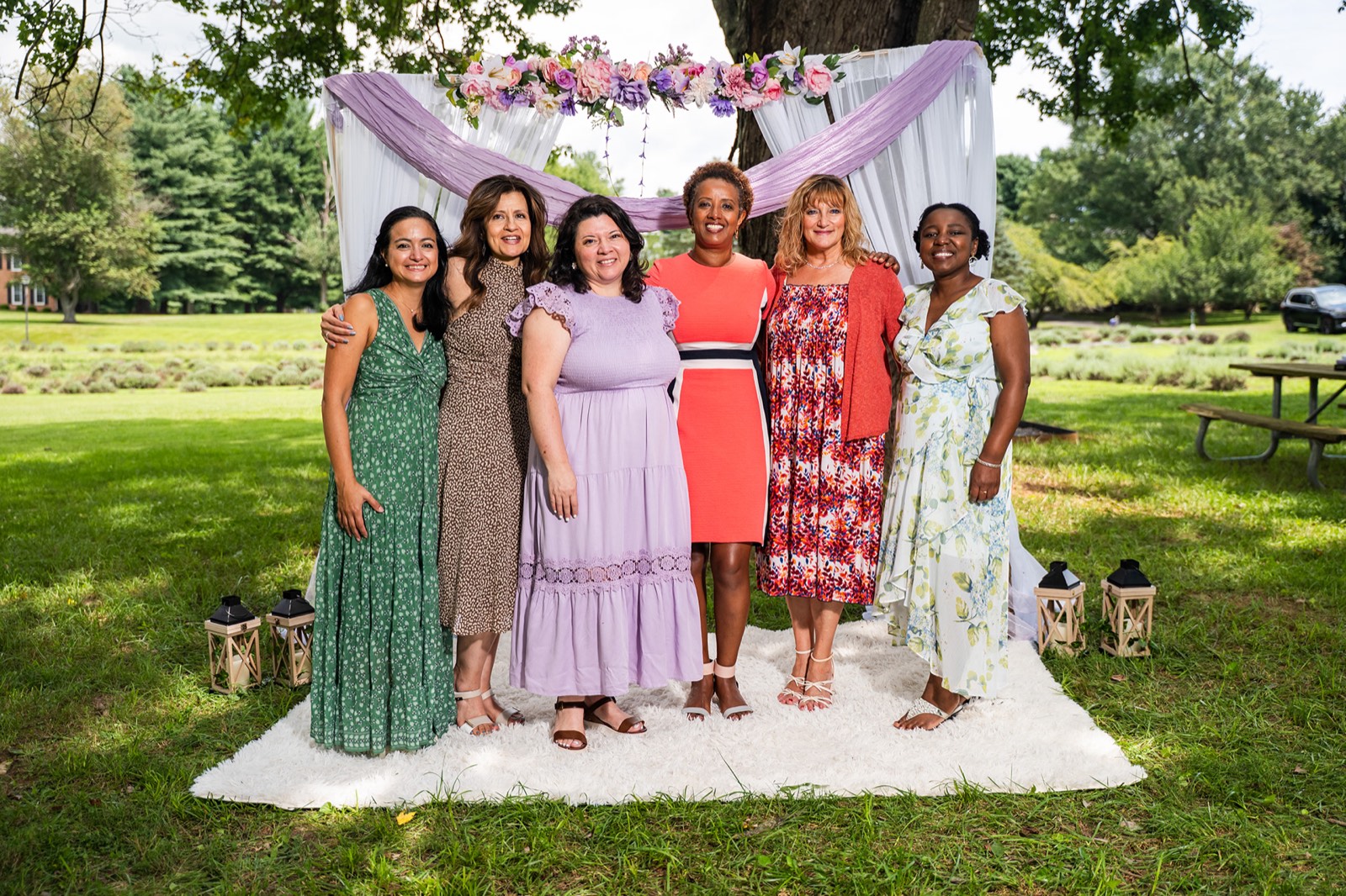 Family group beneath a floral arch