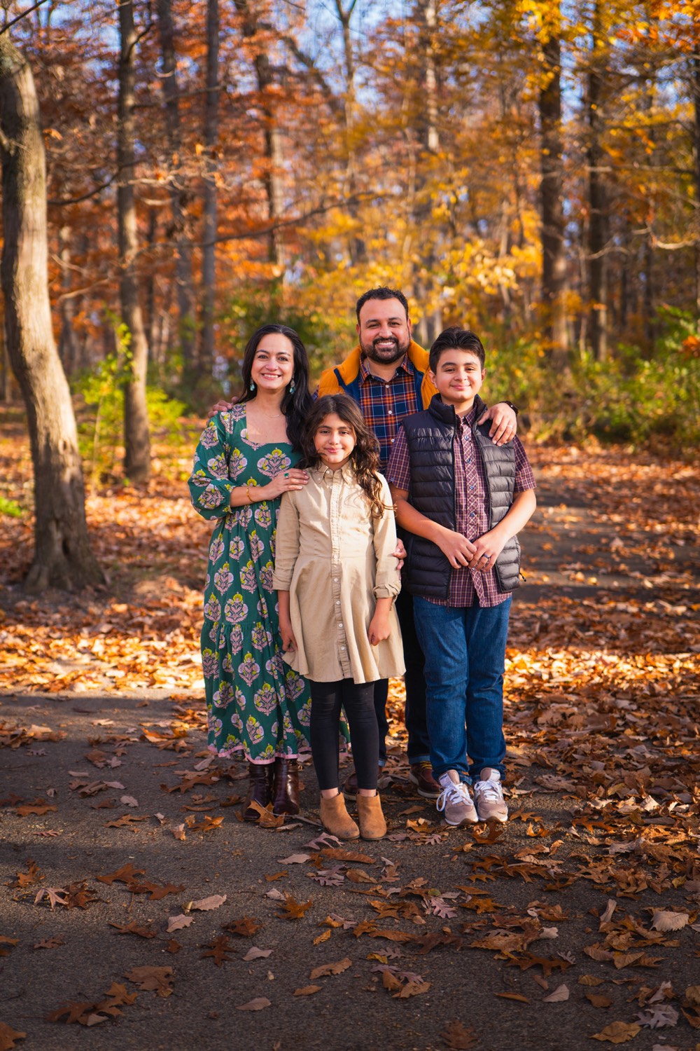 Family with two children among autumn trees
